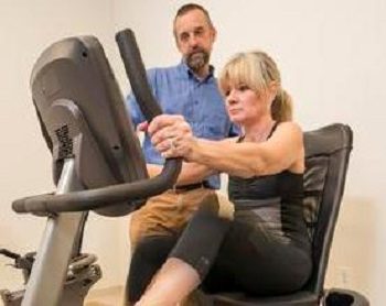 Chris Knight, College of Health Sciences, works with Jody on exercise as part of his Parkinson's research and the effect it has on the patients.